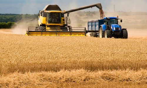 Farming in UK Combine Harvester Loading Tractor